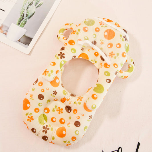 Soft velvet baby nursing and feeding pillow with colorful floral and dot pattern.