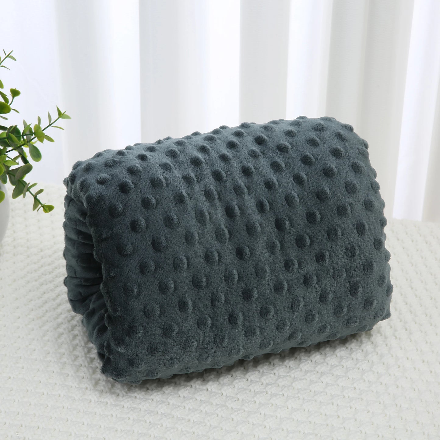Soft gray minky nursing arm pillow with raised dots, designed for comfortable feeding support.
