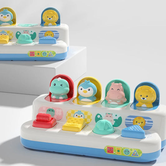 Colorful pop-up toy with animal figures like a lion, penguin, hippo, and dinosaur, featuring interactive buttons.