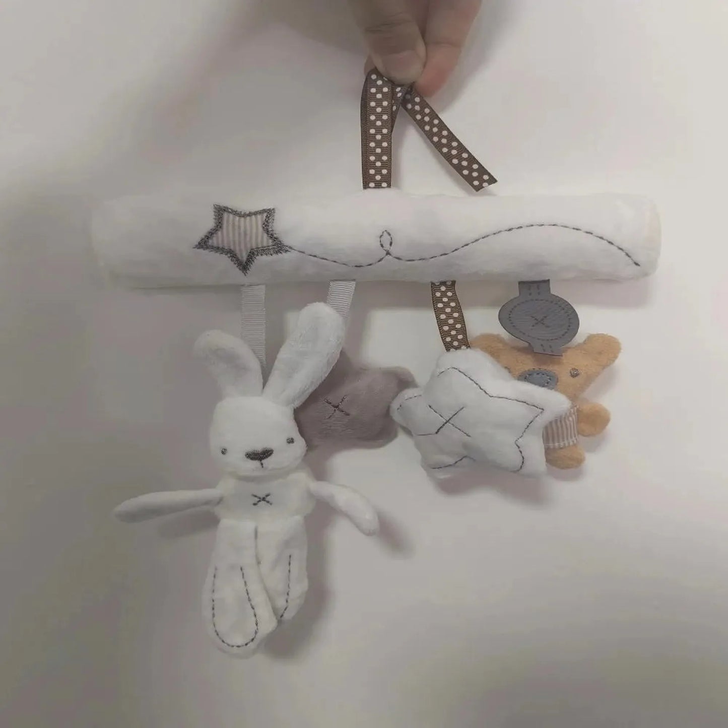 Soft white plush baby rattle mobile with hanging bunny, star, and bear toys.