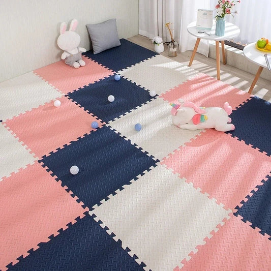Pink, navy, and white interlocking EVA foam puzzle play mat for babies.