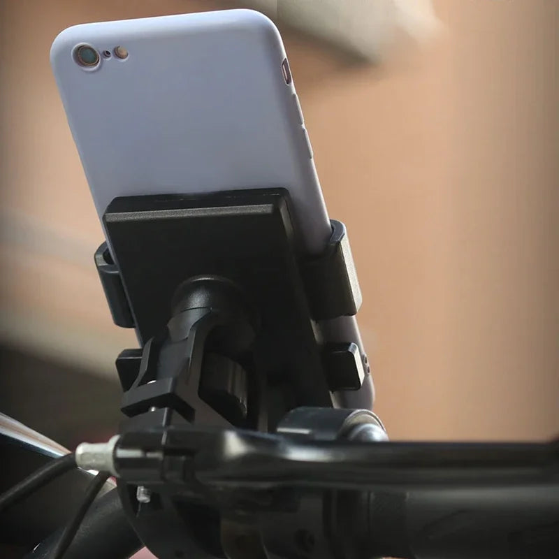 Black universal phone holder for stroller, securely gripping a light purple smartphone.