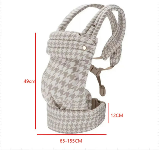 Ergonomic baby carrier in a beige and white houndstooth pattern with padded straps, showing dimensions.