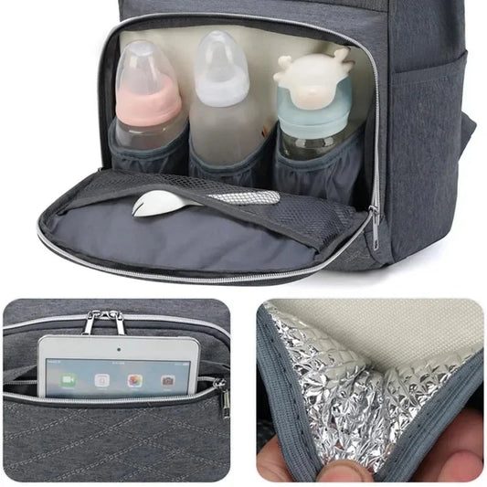 Gray Oxford fabric diaper bag with multiple compartments, including insulated bottle pockets and a tablet sleeve.