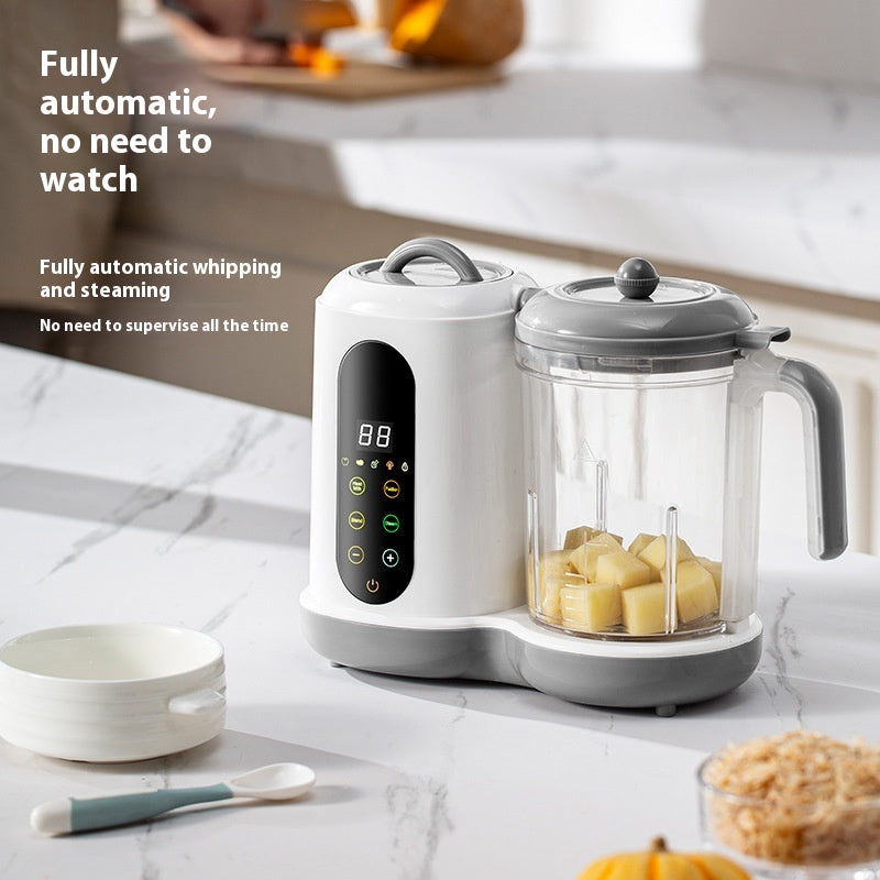 White and gray automatic baby food maker with a clear blending cup filled with diced vegetables.
