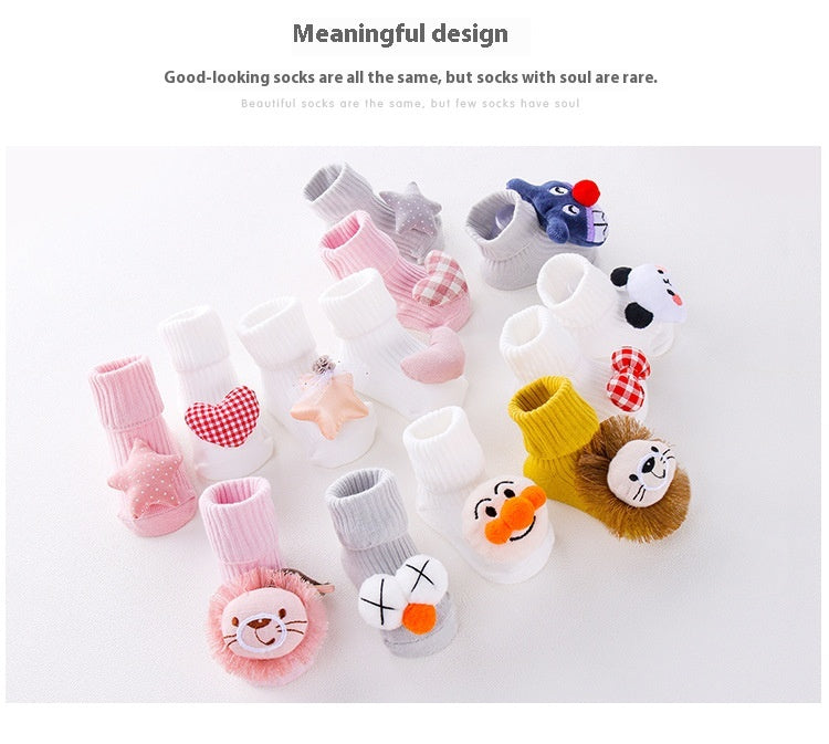 Assorted cotton baby socks with anti-slip soles, featuring cute animal and heart designs in various colors.