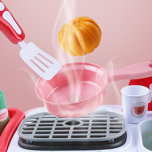 Pink toy kitchen set with steaming pumpkin, spatula, and pan, promoting imaginative play.