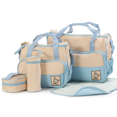 5-piece beige and blue polka dot diaper bag set with two bags, bottle holder, food bag, and changing mat.