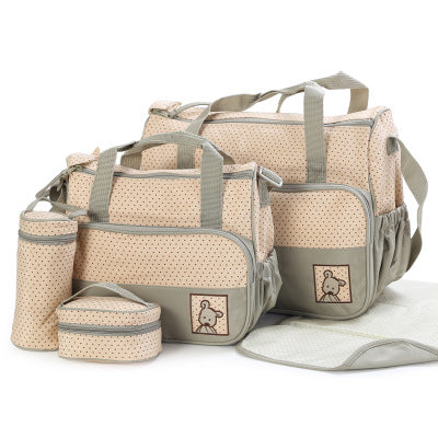 Beige 5-piece diaper bag set with polka dots, grey trim, and bear embroidery, including changing mat.