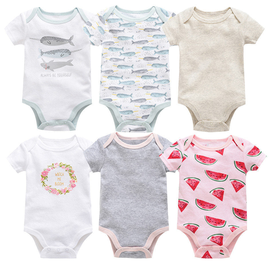Six short-sleeve cotton baby bodysuits: white with narwhals, white with whales, beige, white with floral wreath, grey, and pink with watermelons.