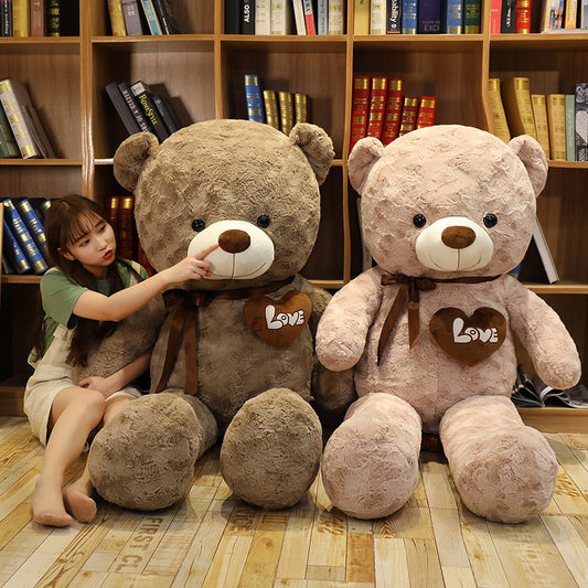 Two large, soft plush teddy bears, one brown and one pink, with "Love" hearts and bows.
