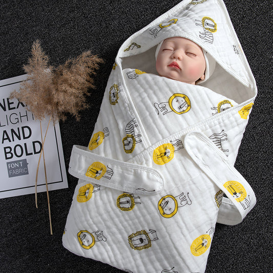 White cotton gauze baby swaddle with yellow lion print, hood, and velcro closure.