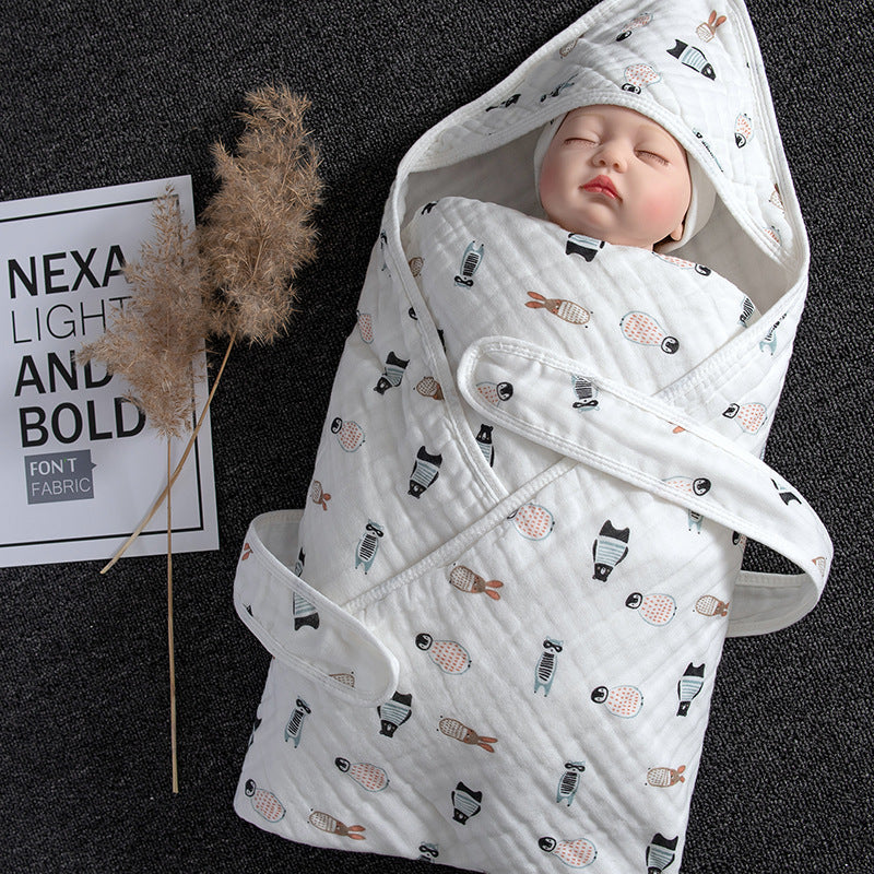 White cotton gauze baby swaddle with hood, featuring a cute animal print and a wrapped doll.