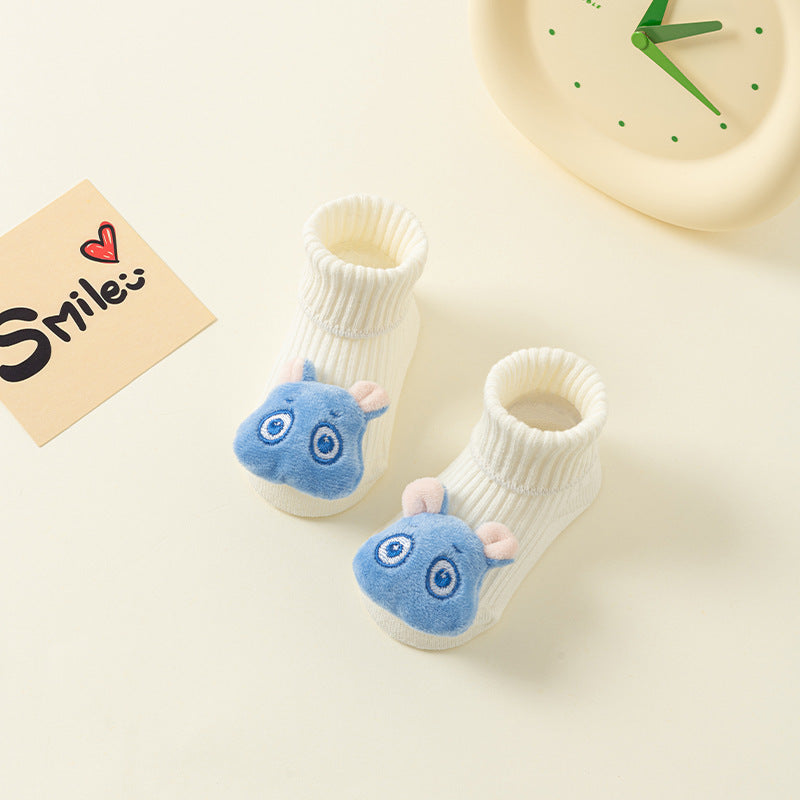 White cotton baby socks with blue animal faces and anti-slip soles.