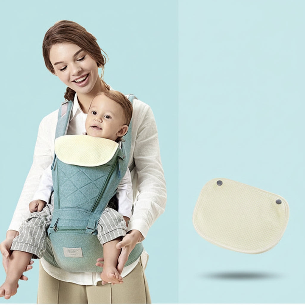 Happy mom carrying baby in a teal ergonomic hip seat carrier with a removable cream bib.