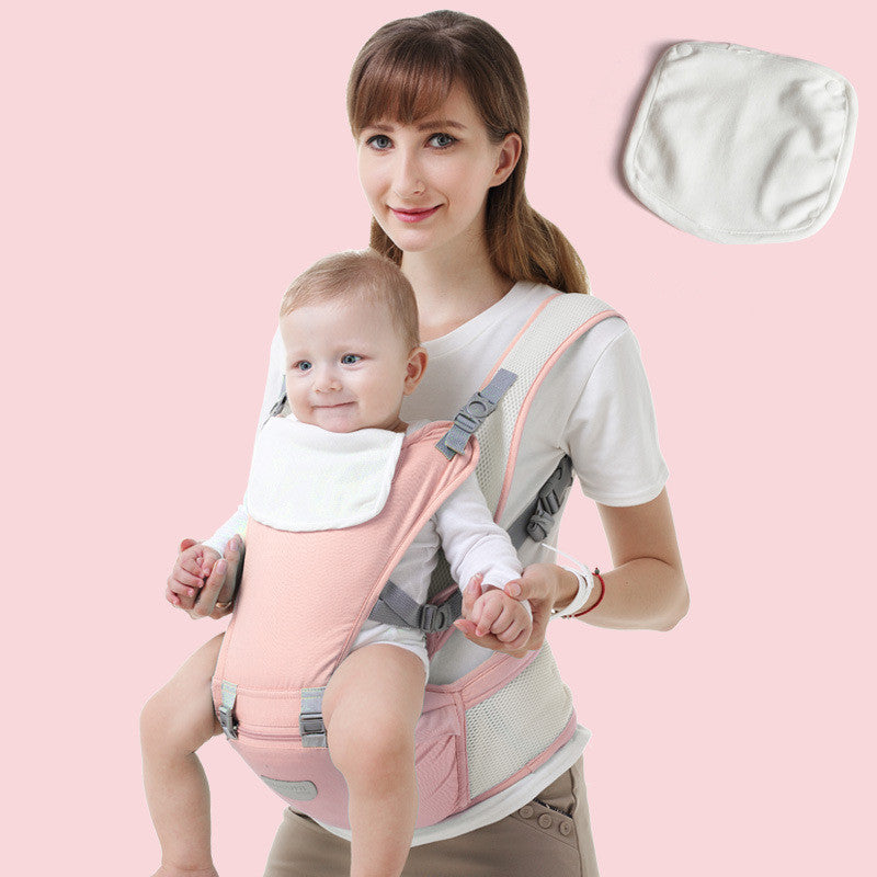 Woman carrying baby in a pink ergonomic hip seat carrier with breathable mesh and a white bib.