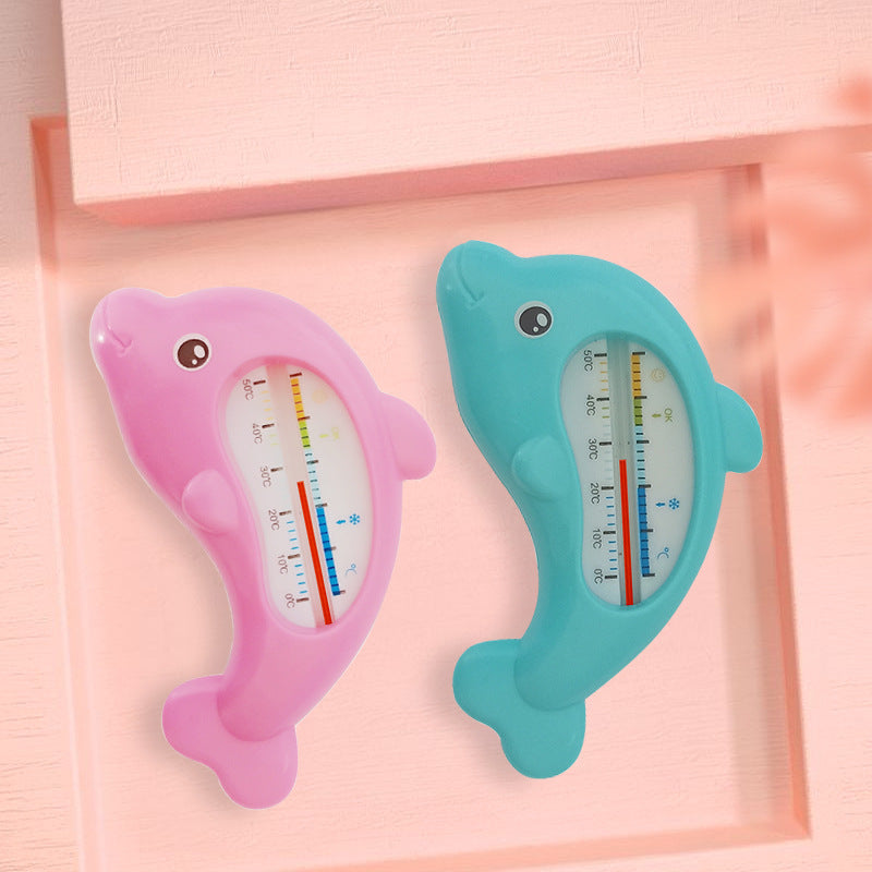 Pink and blue dolphin-shaped baby bath water thermometers with clear temperature scales.