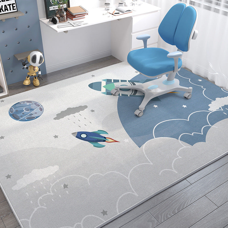 Soft crystal velvet kids' rug with space-themed cartoon rockets, planets, and clouds in blue and gray.