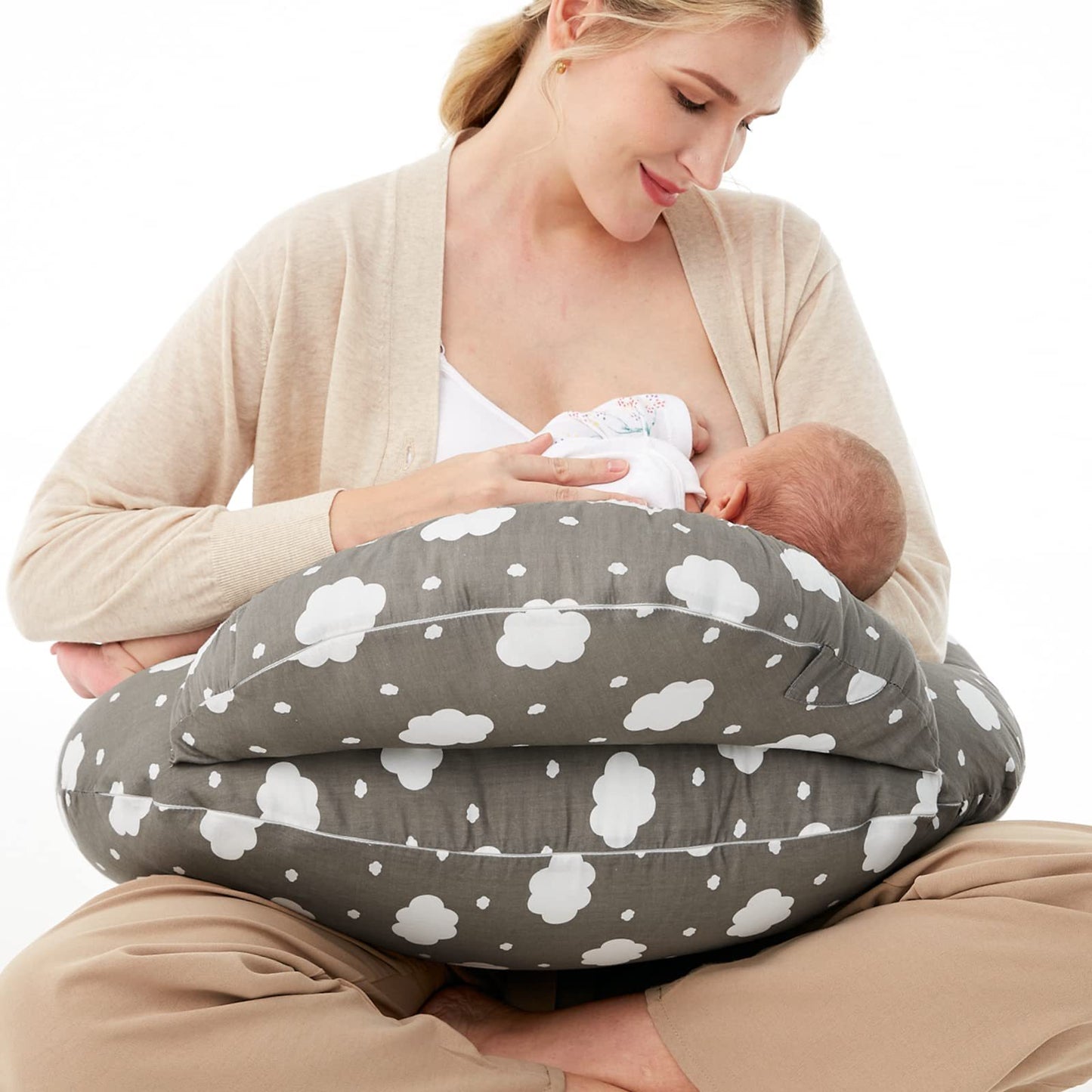 Woman breastfeeding baby using a gray cloud-patterned nursing pillow.