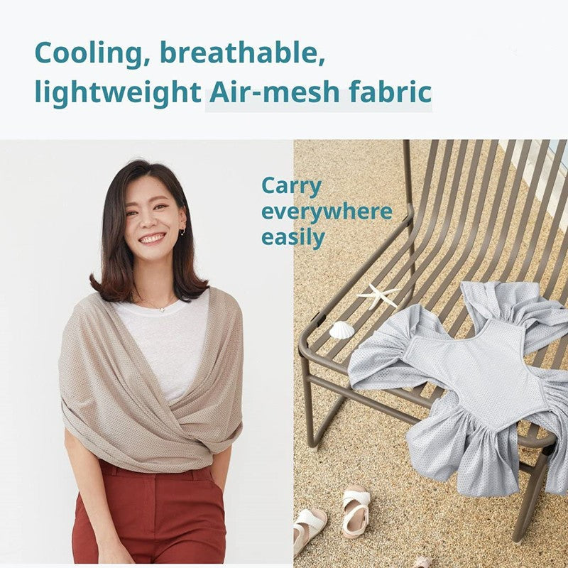 Woman smiling, wearing a beige X-Type ergonomic baby carrier wrap made of cooling, breathable air-mesh fabric.