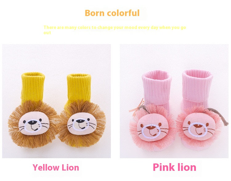 Two pairs of anti-slip cotton baby socks, one yellow with a lion design and one pink with a lion design.