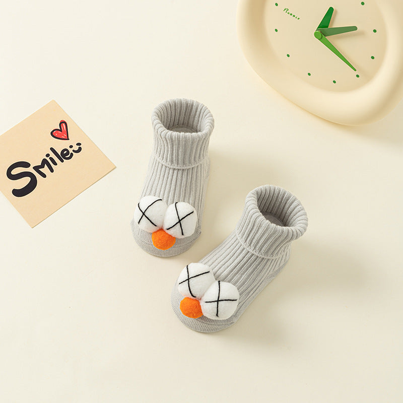 Gray ribbed cotton baby socks with white "X" eyes and orange nose, anti-slip design.