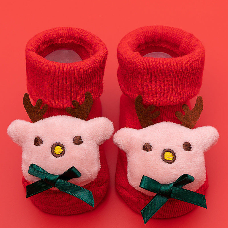 Red cotton baby socks with cute pink reindeer faces, brown antlers, and green anti-slip bows.