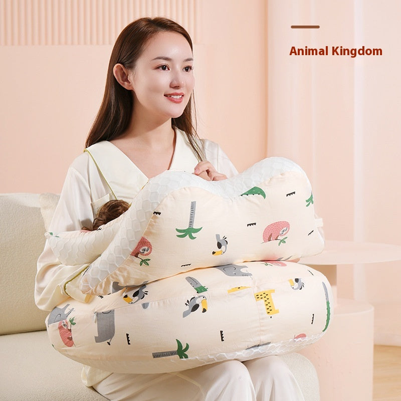 Smiling woman holding a beige nursing pillow with colorful animal and palm tree patterns.