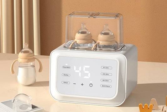White automatic dual baby bottle warmer with digital display, two bottles inside, and a separate bottle on the side.