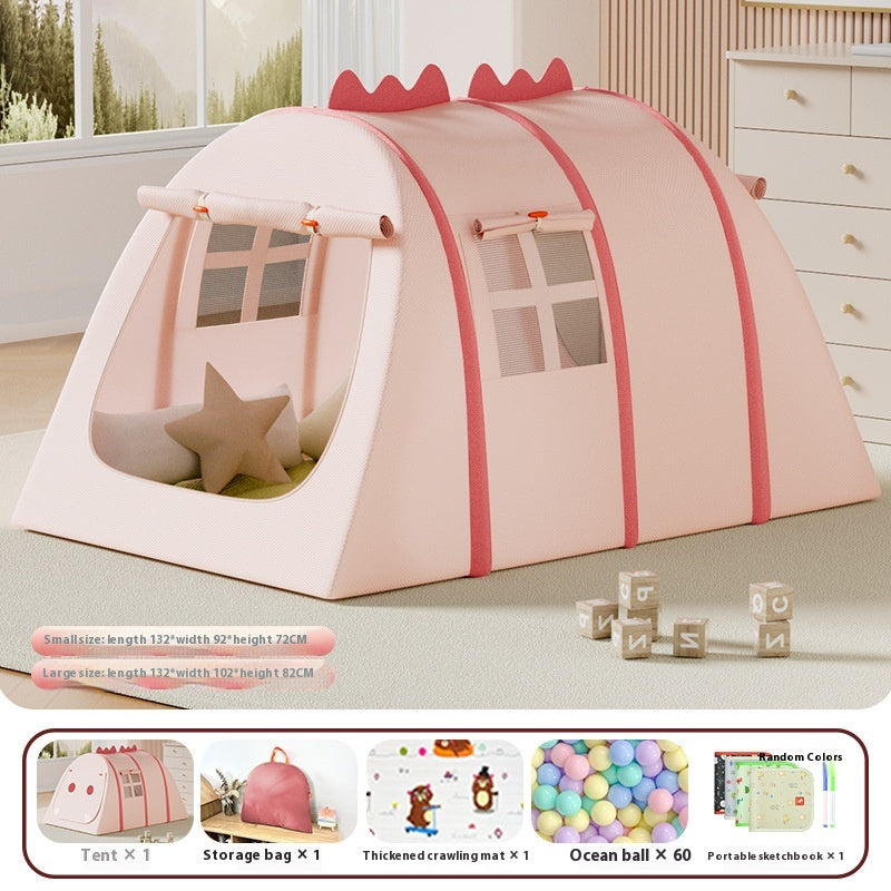 Pink fabric children's play tent with windows, dinosaur spikes, and a star pillow, shown indoors.