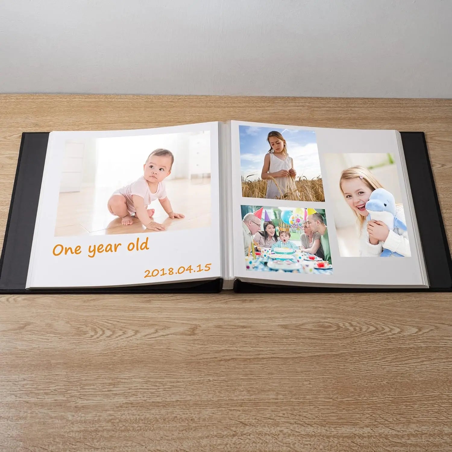 Open black linen photo album with sticky pages displaying baby, child, and family birthday photos.