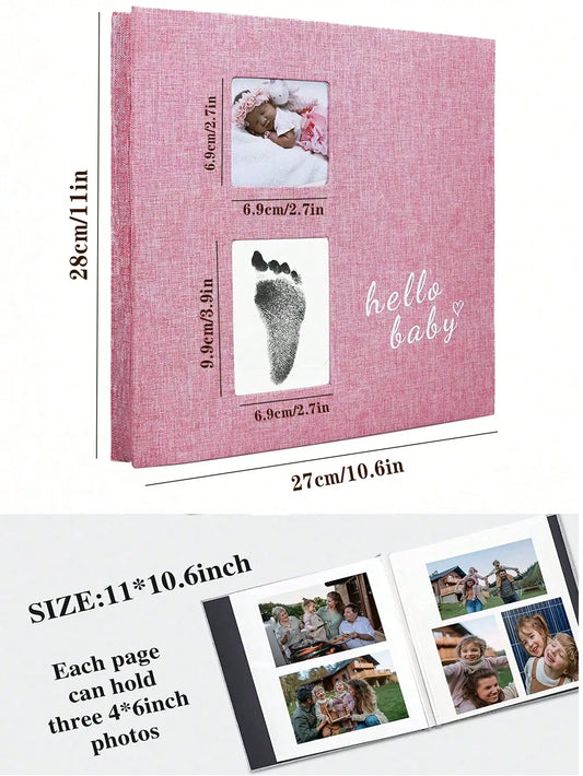 Pink linen baby photo album with footprint kit, "hello baby" embroidery, and two photo windows.