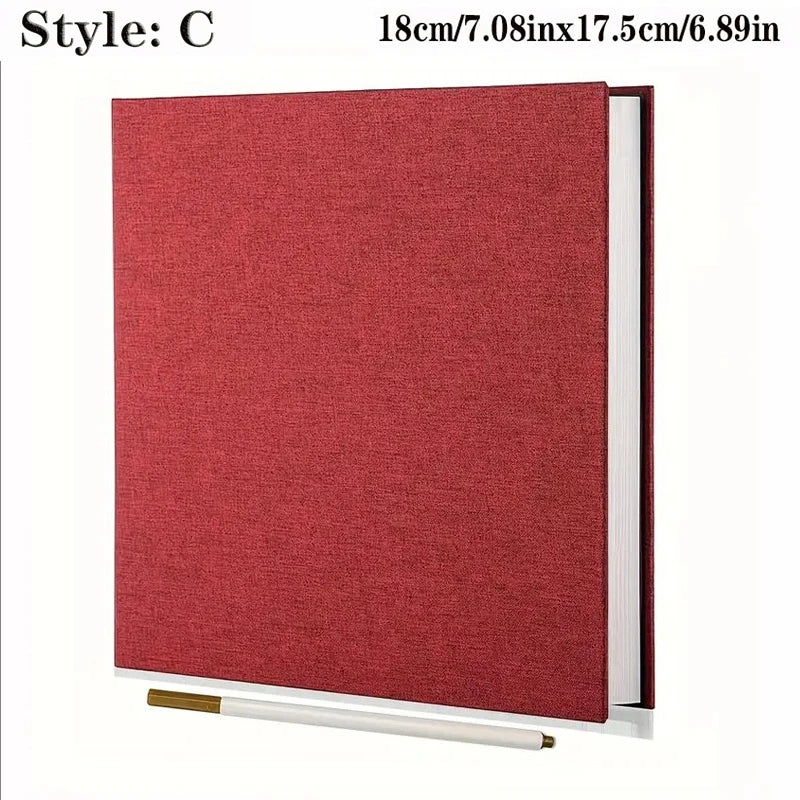 Red linen self-adhesive photo album with spiral binding, 18x17.5cm, shown with a white pen.