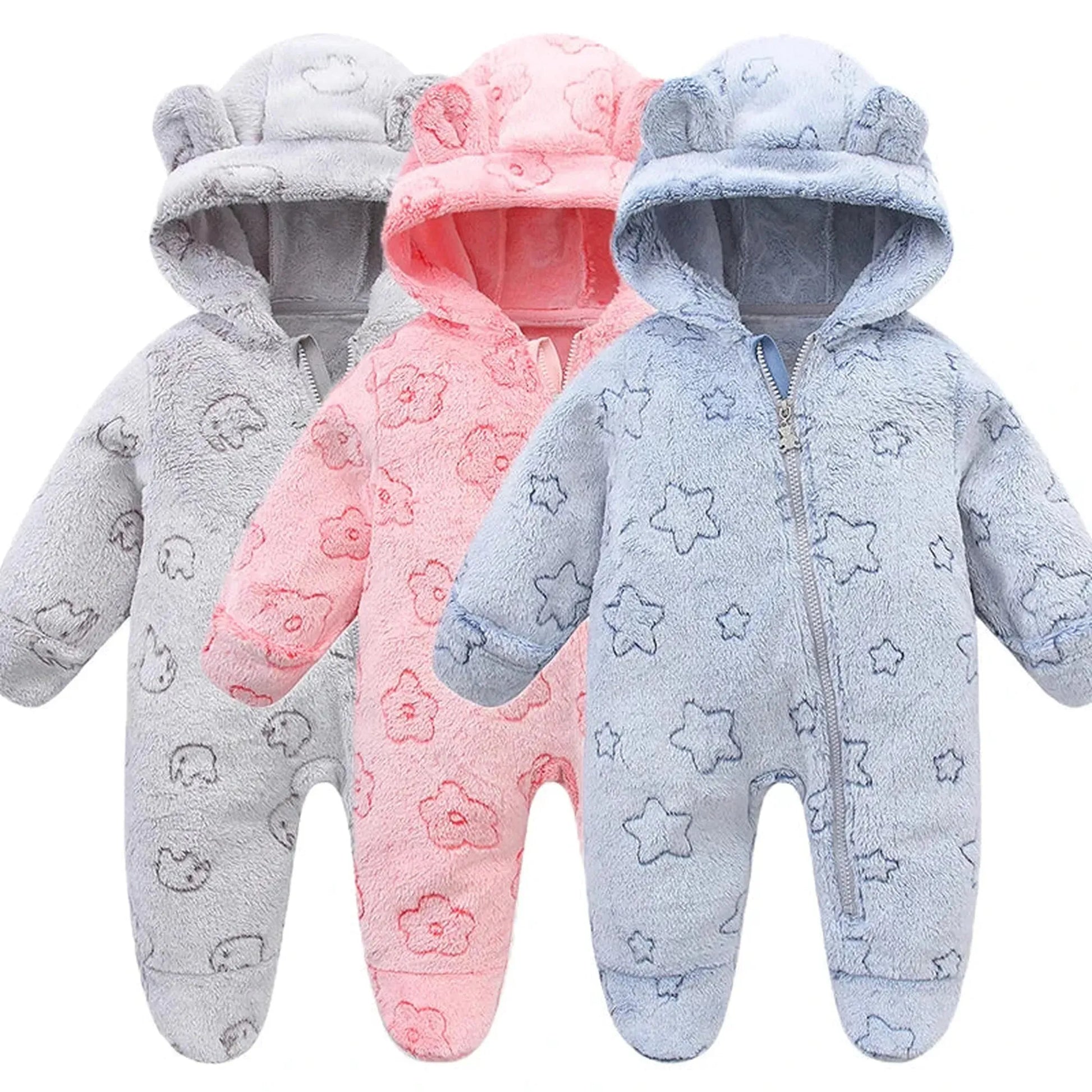 Three plush flannel baby rompers with ear hoods: grey with elephants, pink with flowers, and blue with stars.