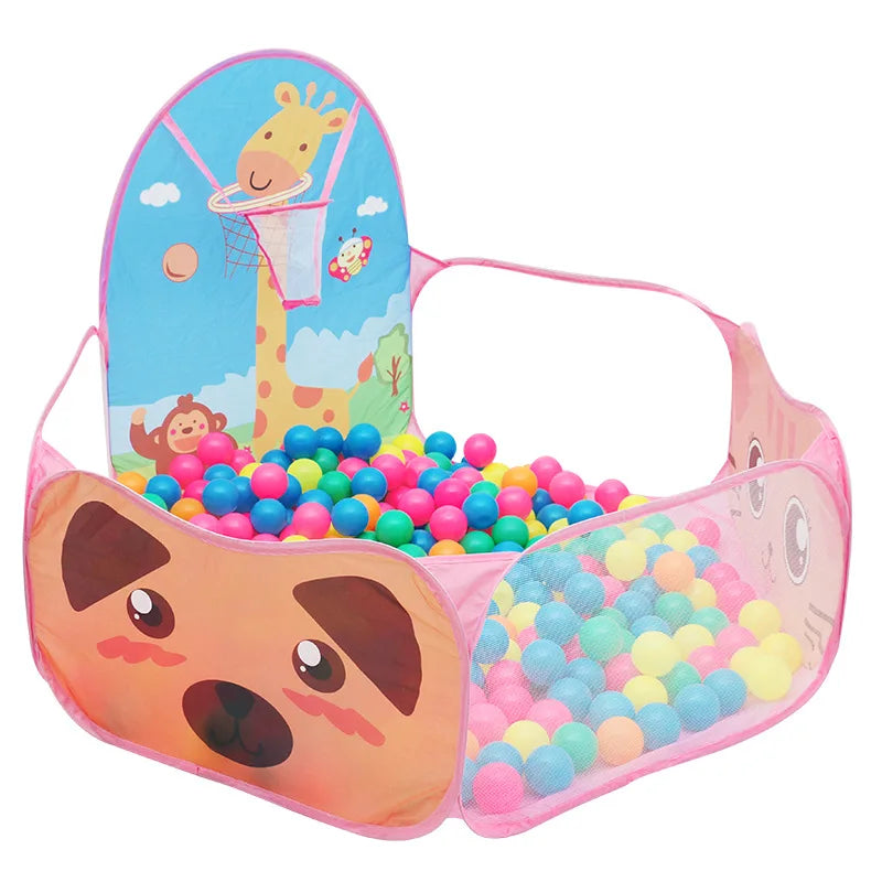 Pink foldable kids' play tent with basketball hoop, giraffe, monkey, and dog designs, filled with colorful balls.