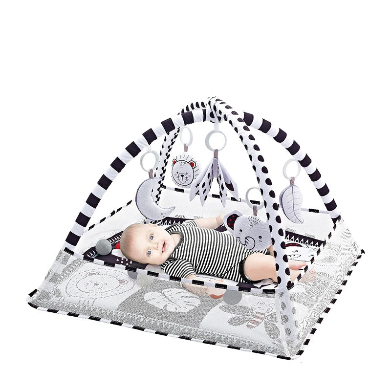 Baby activity gym with black and white striped arch, soft mat, and hanging animal toys.