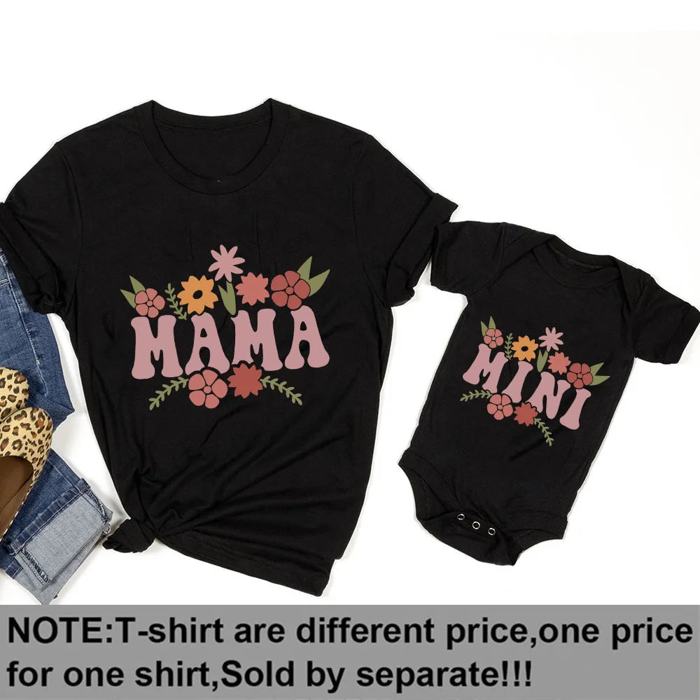 Black short-sleeve "Mama" t-shirt and "Mini" baby bodysuit with colorful floral designs.