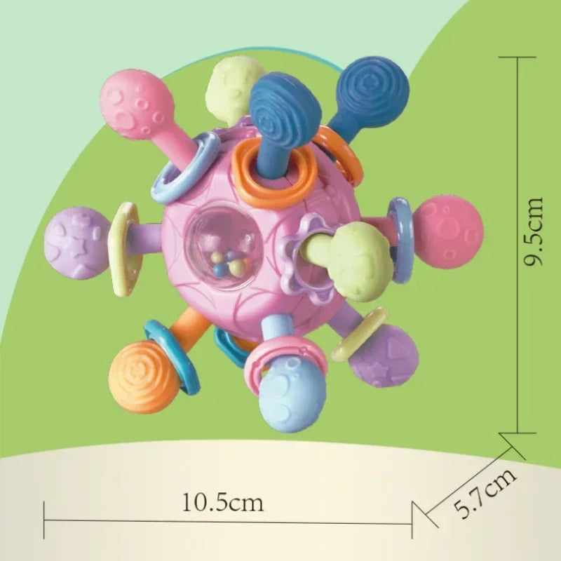 Pink silicone spinning rattle ball for babies, with colorful textured arms and a clear center showing beads.