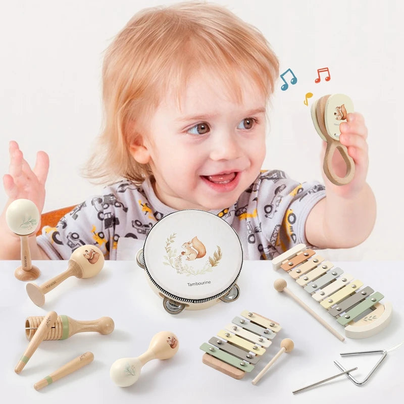 Toddler playing with a Montessori wooden musical instrument set, including a tambourine, maracas, xylophones, and a triangle.