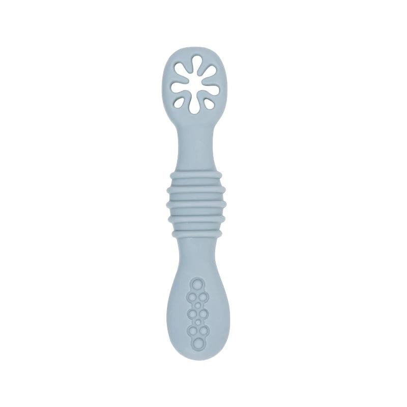 Light blue silicone baby training spoon with textured handle and flower-shaped feeder.