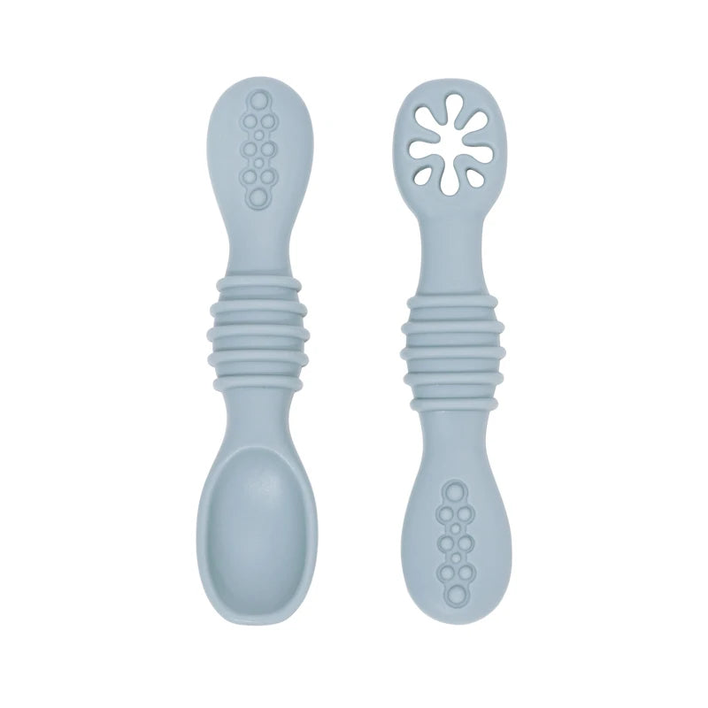 Two light blue silicone baby training spoons with textured handles and soft tips.