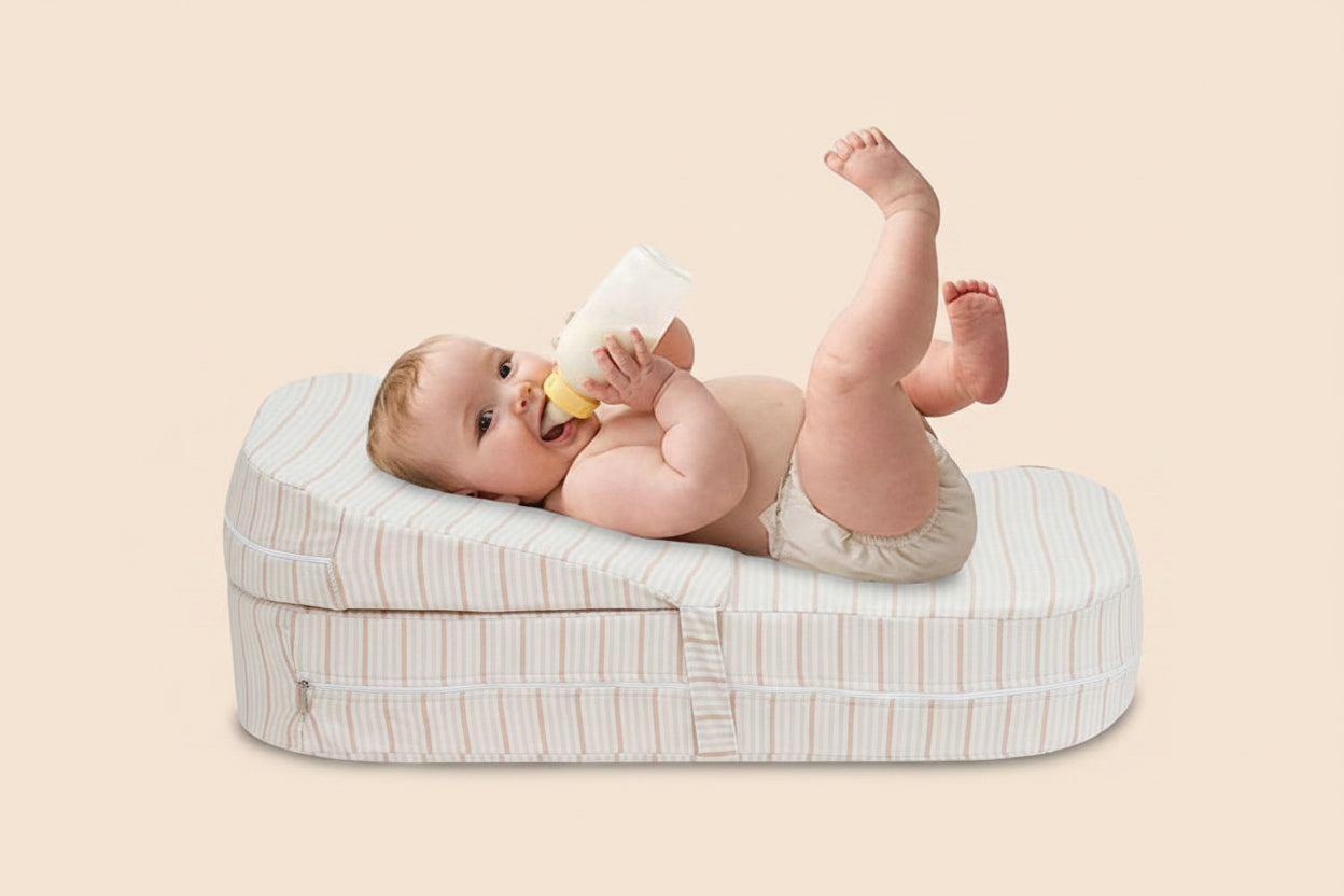 Baby on a striped adjustable anti-reflux feeding pillow, with diagrams illustrating its ergonomic design.
