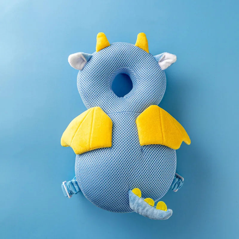 Blue mesh baby head protector with yellow dragon wings, horns, and tail.