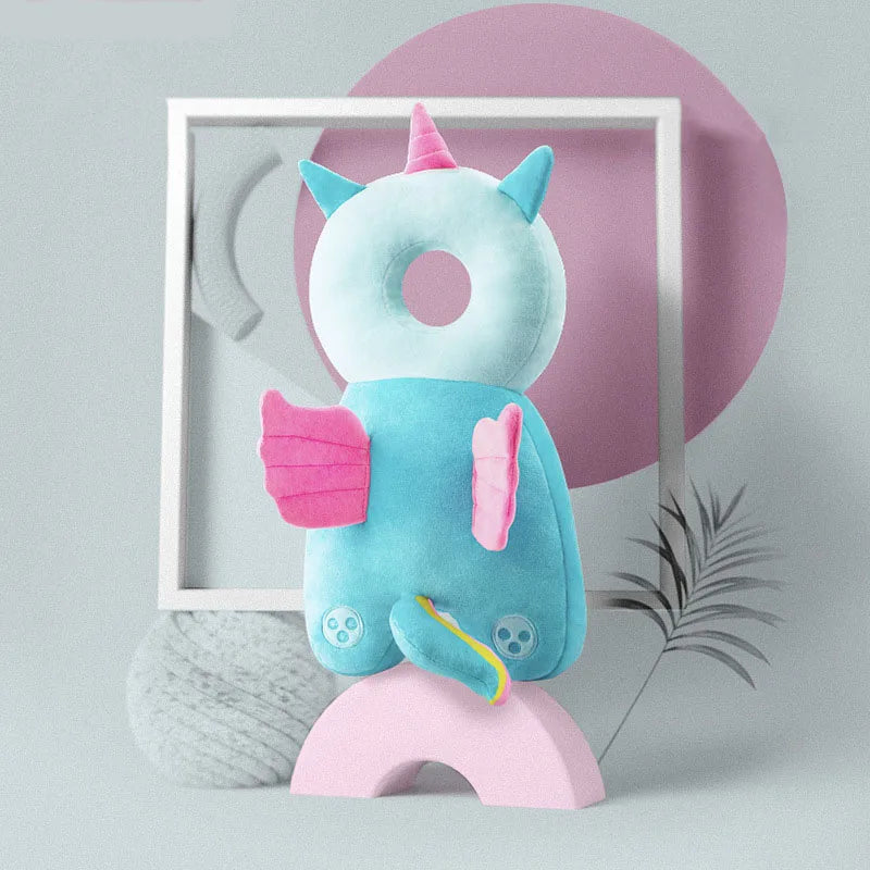 Blue unicorn baby head protection pillow with pink wings and horn, for fall safety.