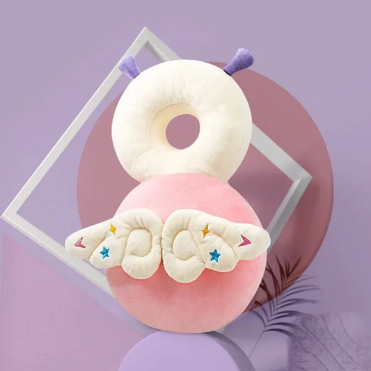 Pink baby head protection pillow with white top, purple antennae, and star-embroidered wings.