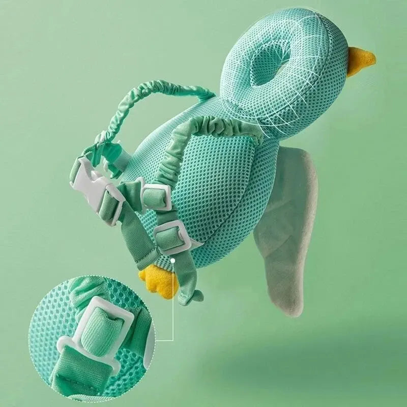 Green duck-shaped breathable baby head protection pillow with adjustable straps and soft padding.