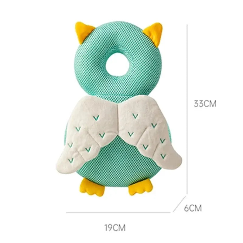 Green owl baby head protector with white wings, yellow ears, and feet, showing 33cm height.