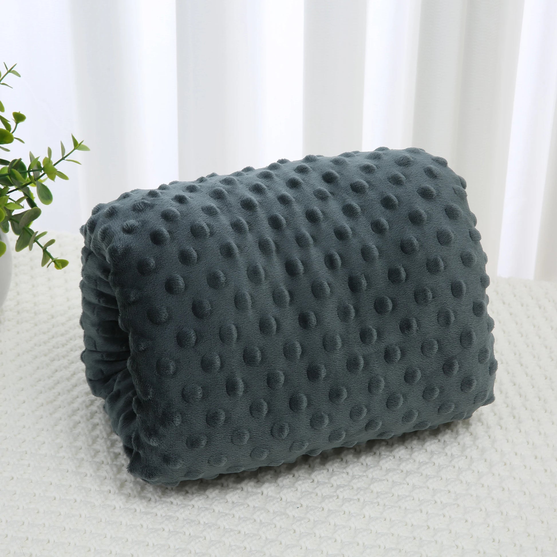 Soft gray minky nursing arm pillow with raised dots, designed for comfortable feeding support.