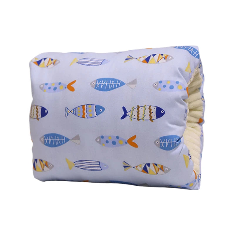 Light blue nursing pillow with colorful fish pattern, soft yellow inner lining, for arm and neck support.