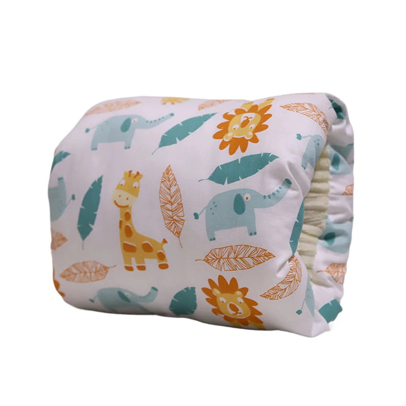 White cotton nursing pillow with colorful safari animal and leaf print.
